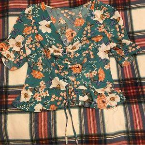 Green floral top with adjustable strings in the front